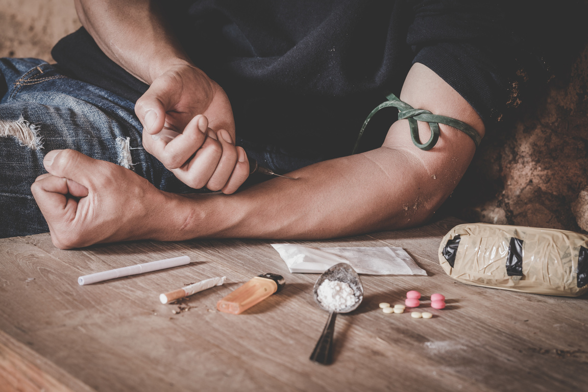 Man drugs addicted injecting heroin in his arm, Drug addict man with syringe using drugs, Drugs concept, 26 June, International Day Against Drug abuse.